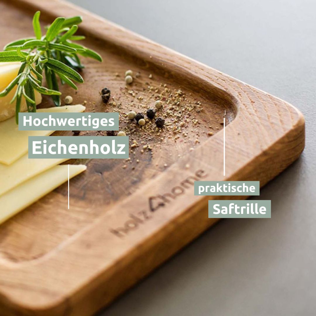 Close-up van de serveerplank van eikenhout met sapgroef, belegd met kaas, rozemarijn en peperkorrels