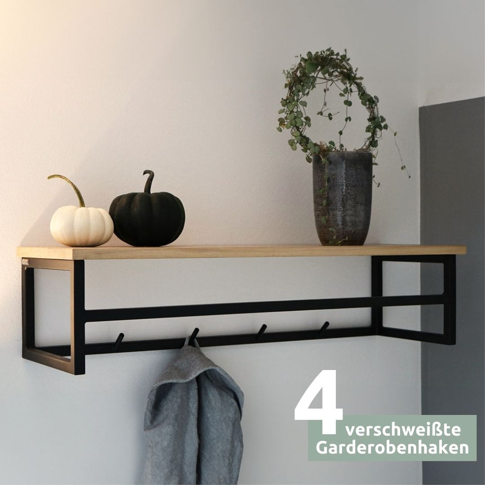 Wandkapstok van eikenhout met zwart frame en haakstrip aan de muur met decoratieve pompoenen en handdoek