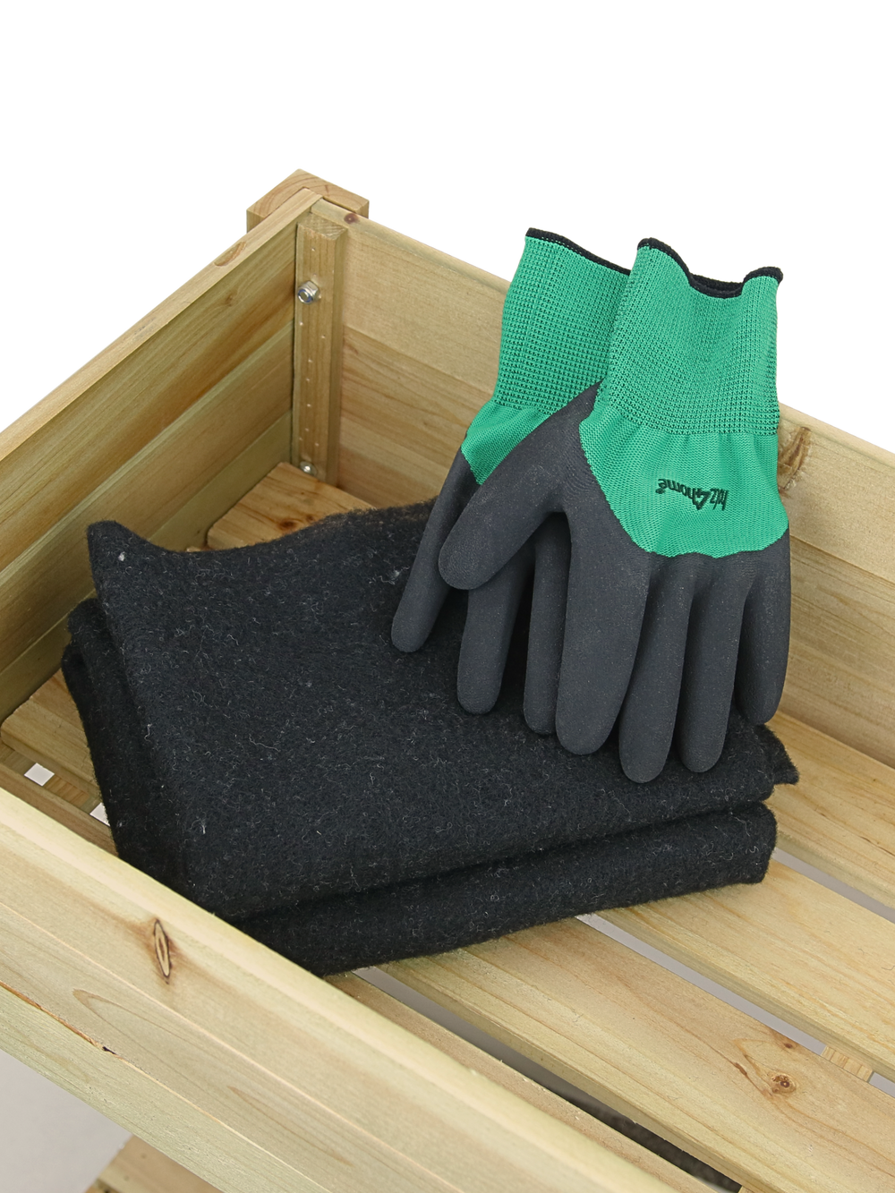 Meegeleverde accessoires: zwarte vliesinlage en tuinhandschoenen in de moestuinbak