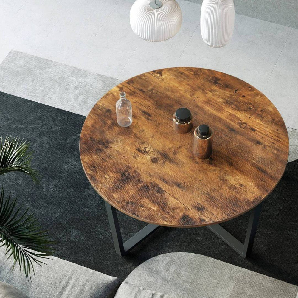 Bovenaanzicht van het rustieke houten blad van de ronde salontafel Indie
