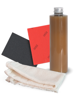Onderhoudsset met fles onderhoudswas, twee schuurpads en katoenen doek voor houten meubels, vrijstaand getoond