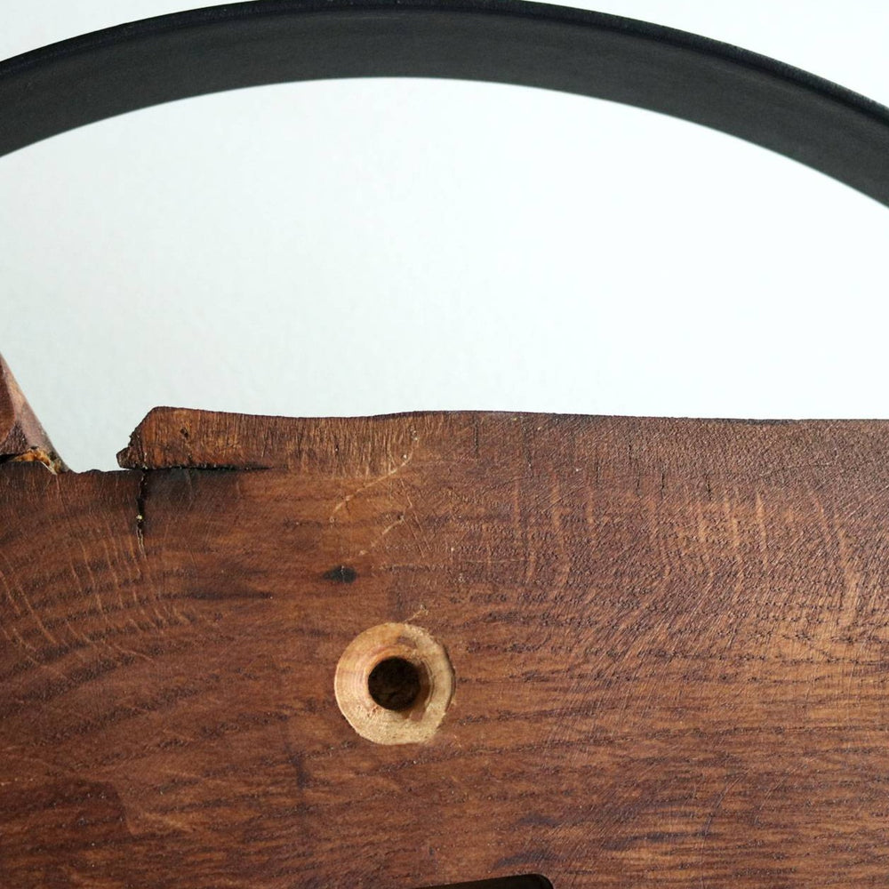 Achterzijde van de eikenhouten plank van de wandklok Artwork met ophanggat en zwarte metalen ring
