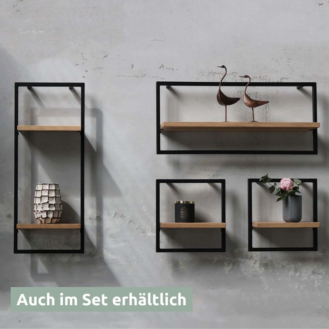 Wandrekkenset aan grijze muur: hoog, lang en twee kleine zwart omlijste rekken met decoratieve vogels en vaas